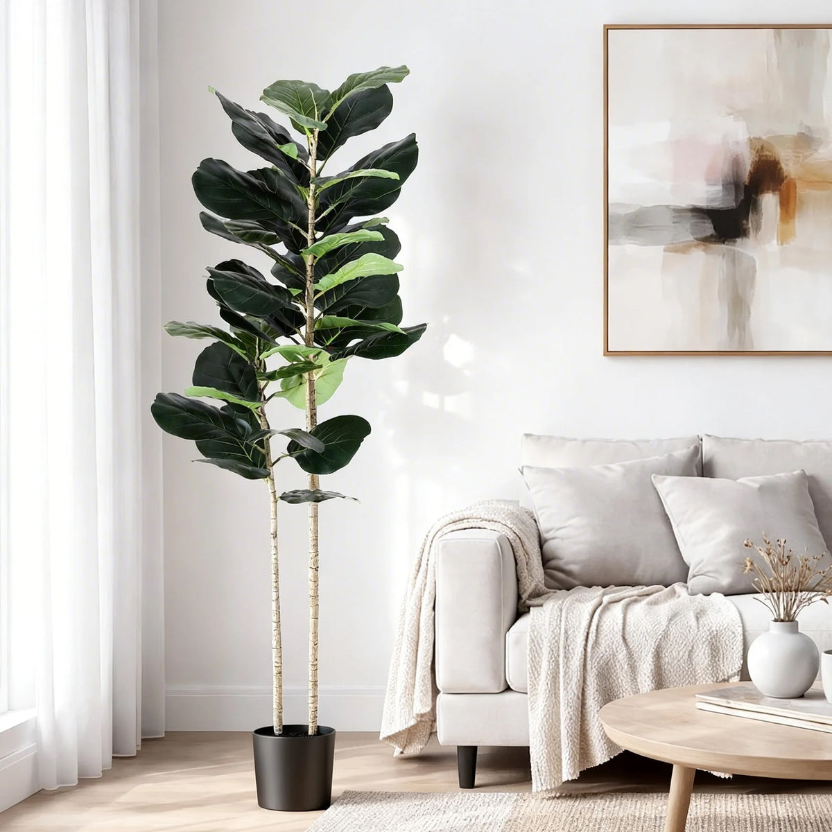 Artificial fiddle tree with dark green faux leaves and tall stems in a black pot