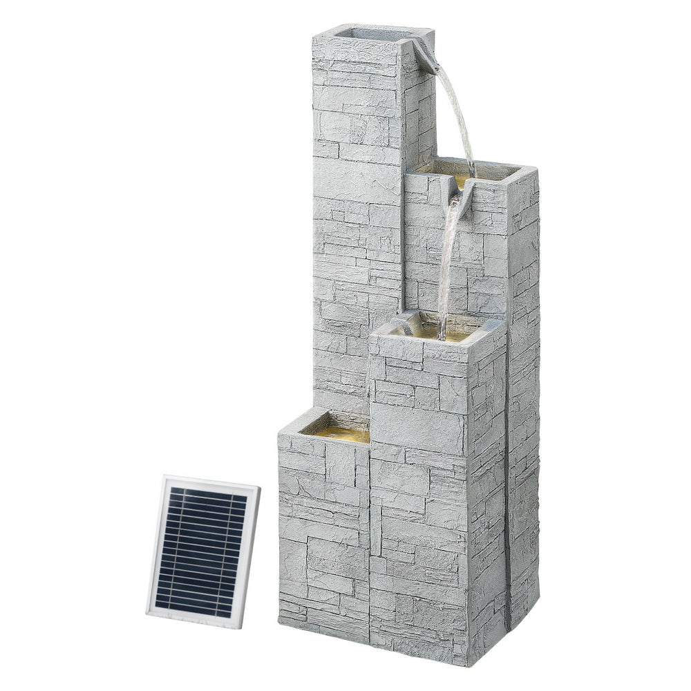 Outdoor water fountain with stone-like design and solar panel on a white background