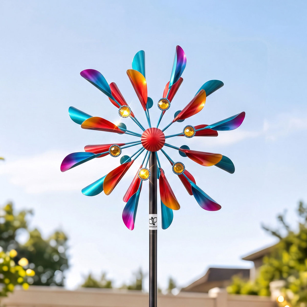 Colorful metal double windmill spinner with red hub and circular blade arms