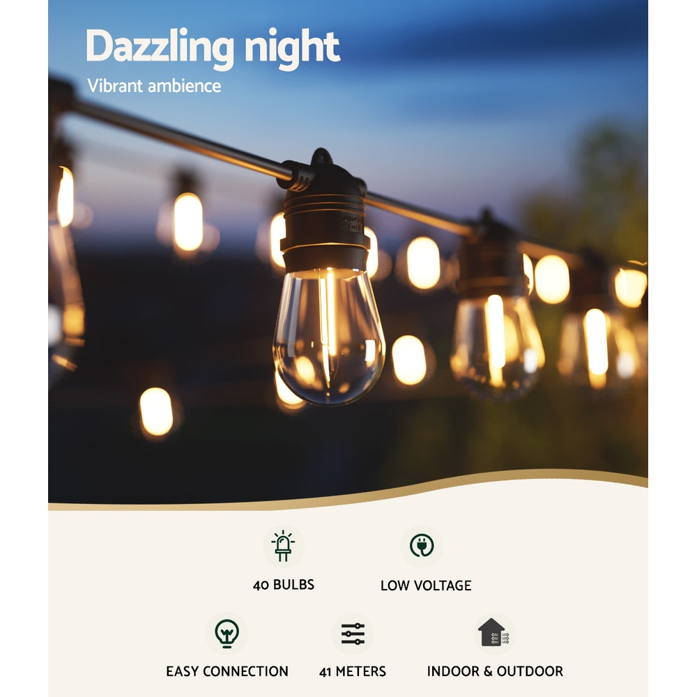 Outdoor string lights with glowing vintage bulbs hanging across an evening patio