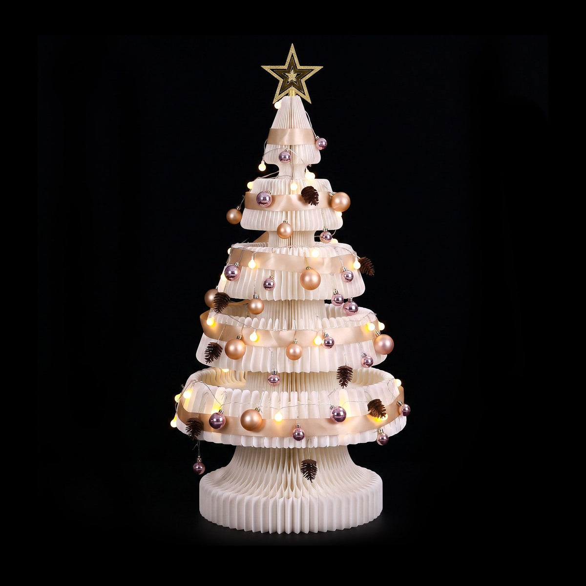 White pop-up paper Christmas tree with warm LED lights and gold star topper, full front view
