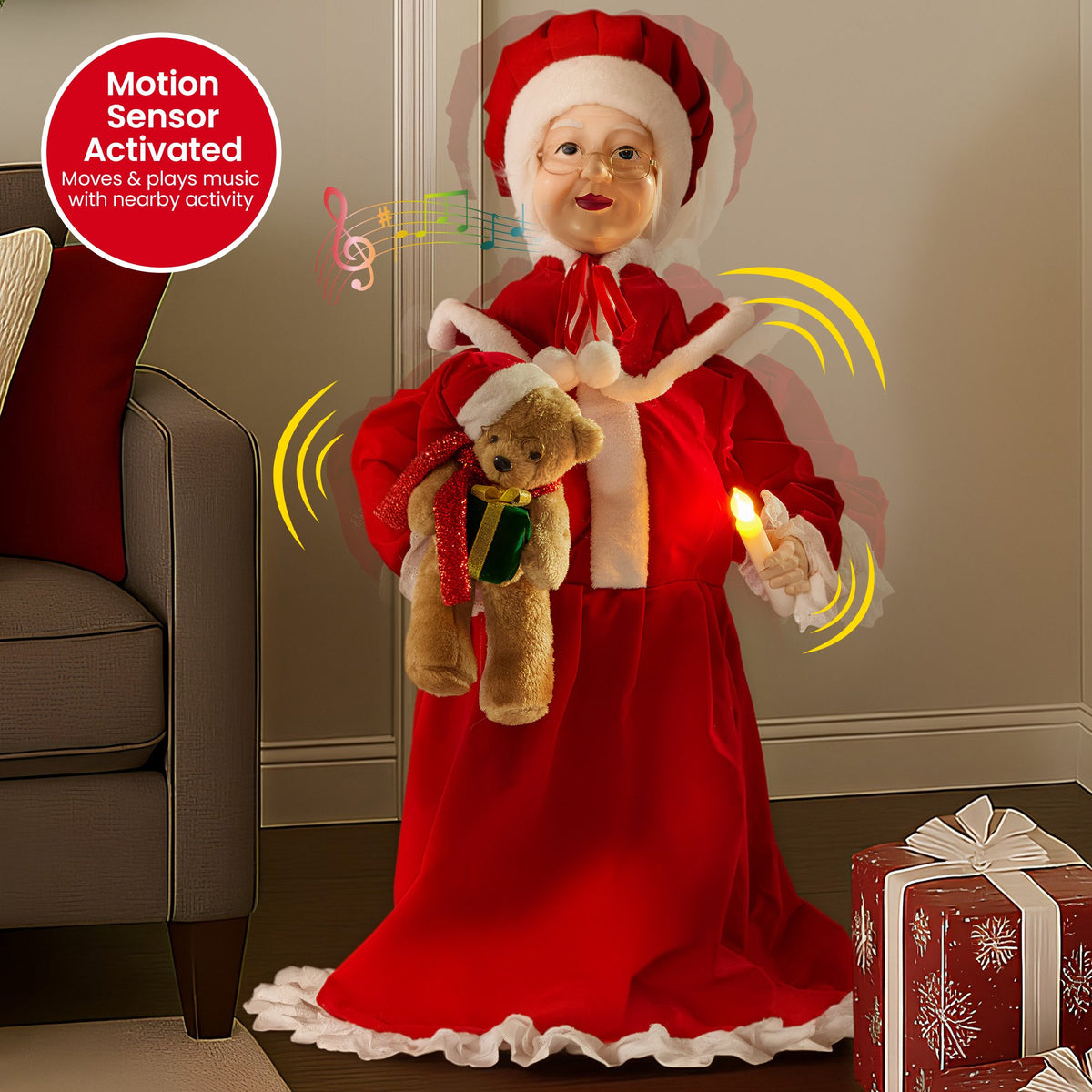 Motion-sensor Mrs Claus glowing candle decoration in red dress with teddy bear
