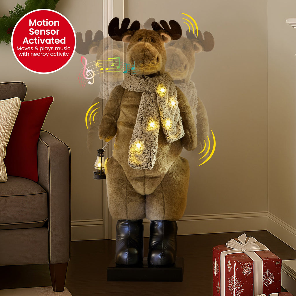 Plush LED moose ornament with scarf and lantern, warm yellow lights shining