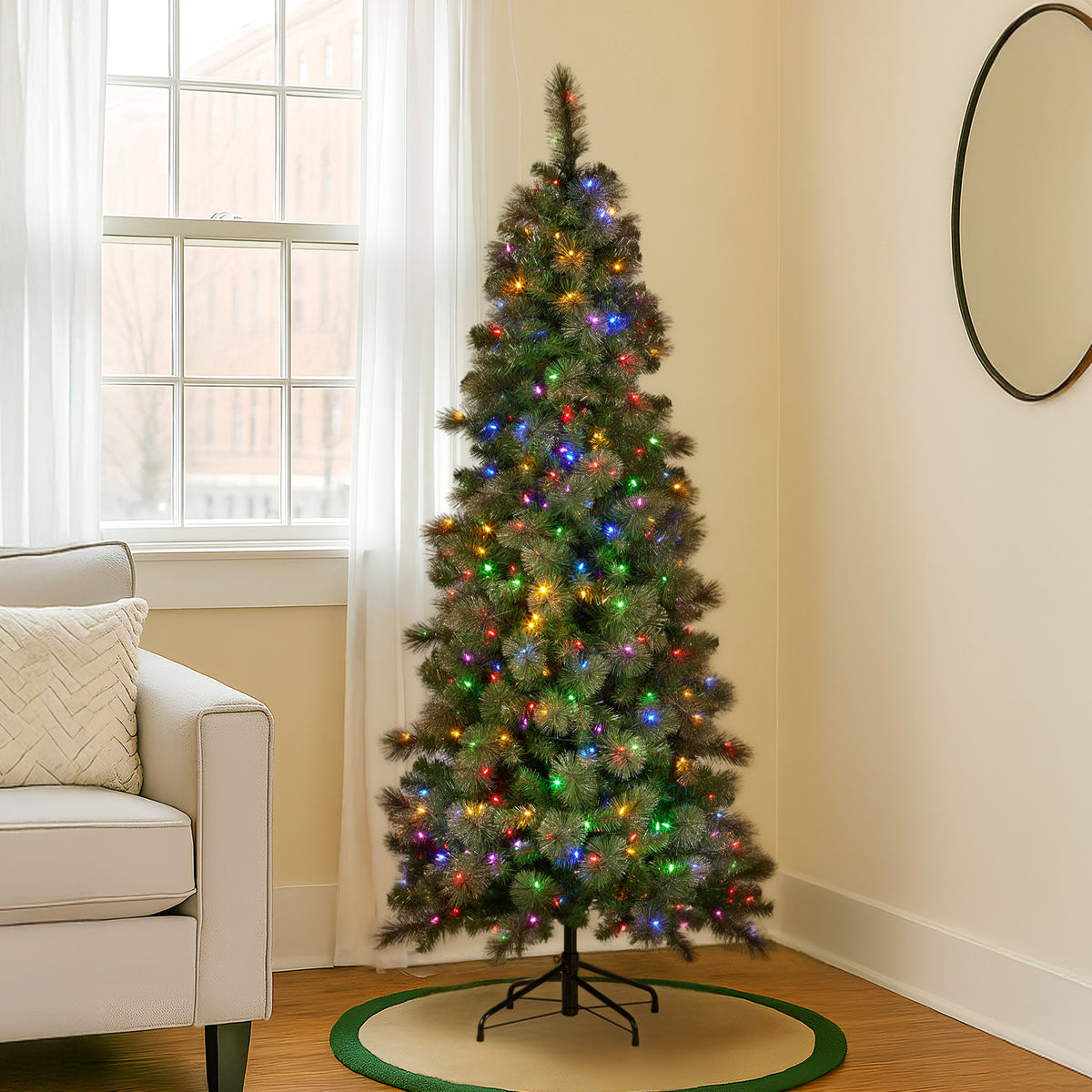 Slim Christmas tree with glittery gold foliage and multicolor LED lights on round base.
