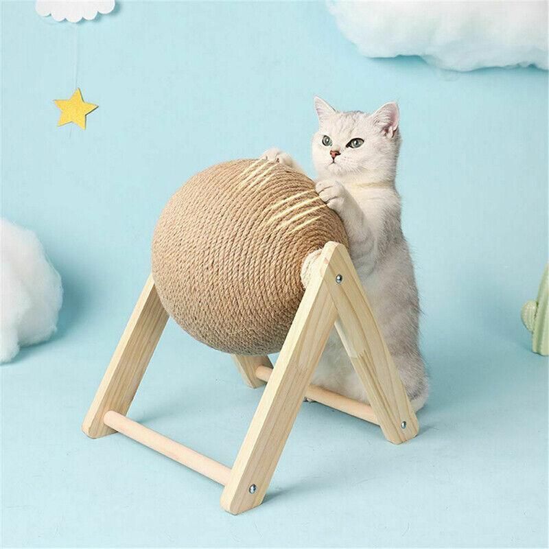 Cat using natural sisal scratching ball toy on light wood stand
