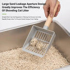 Grey litter box with scoop and filter grate, holding clumps above bedding