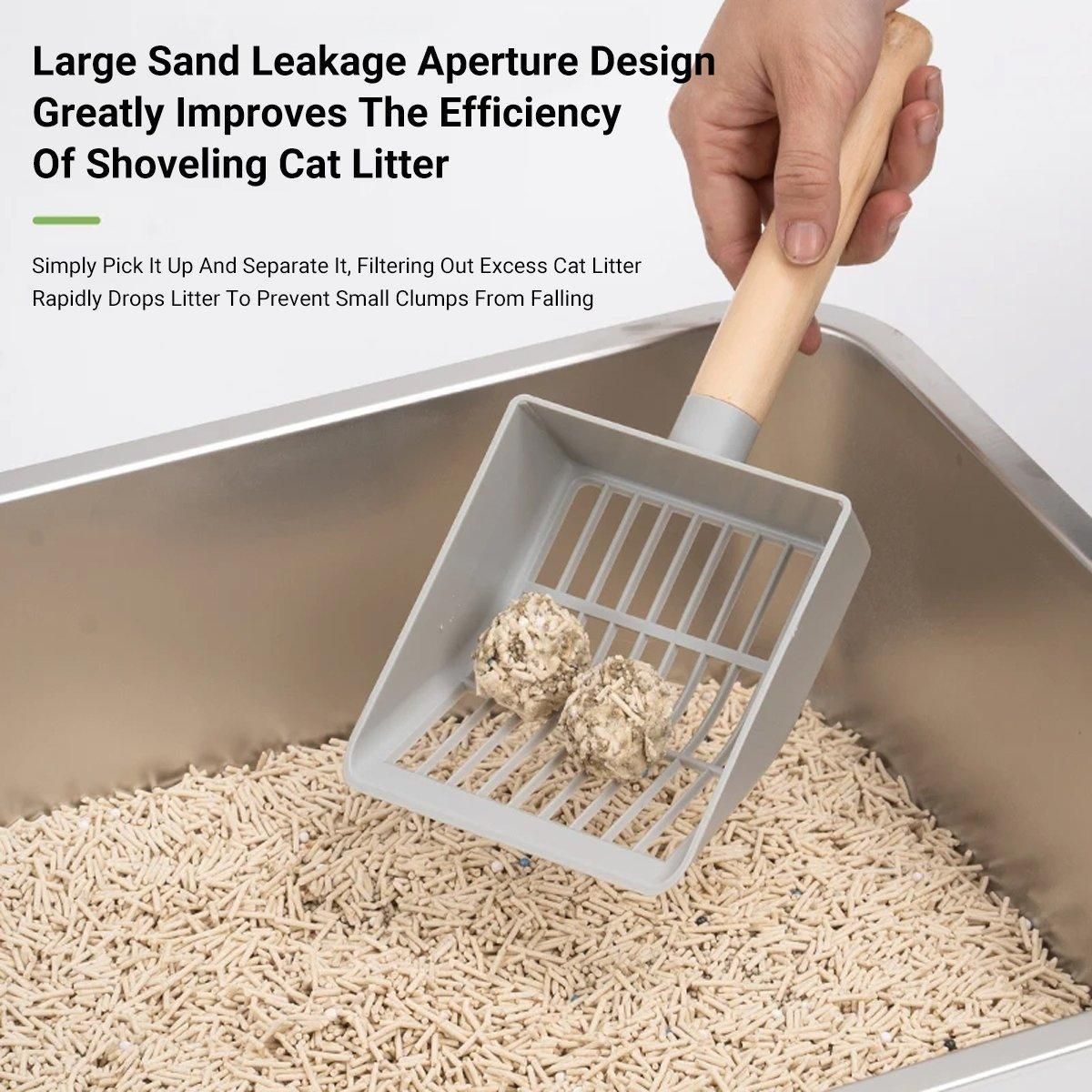 Grey litter box with scoop and filter grate, holding clumps above bedding
