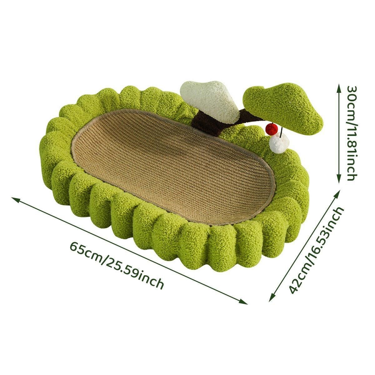 A green plush cat bed with a wavy fringed edge, a tan woven scratching pad inside, and a small white-and-green cat tree topper, shown with dimension arrows and labels on a white background.