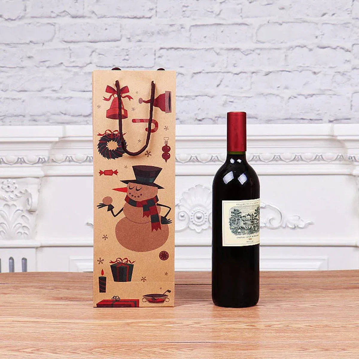 Kraft wine bottle gift bag with snowman design standing next to a wine bottle