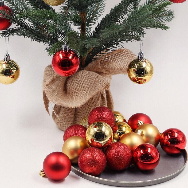 Christmas tree ornament baubles in red and gold tones around hanging red and gold spheres
