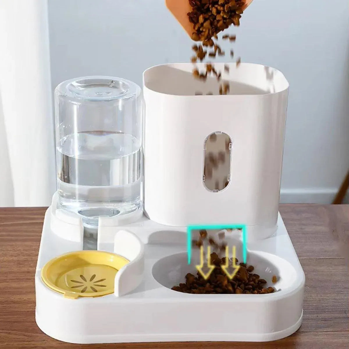 2-in-1 pet feeder and water dispenser with kibble pouring into the feeding tray