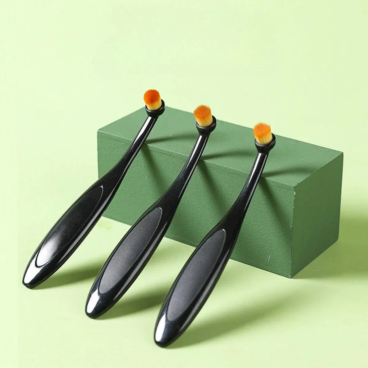Set of three black pet stain remover brushes with orange bristle heads