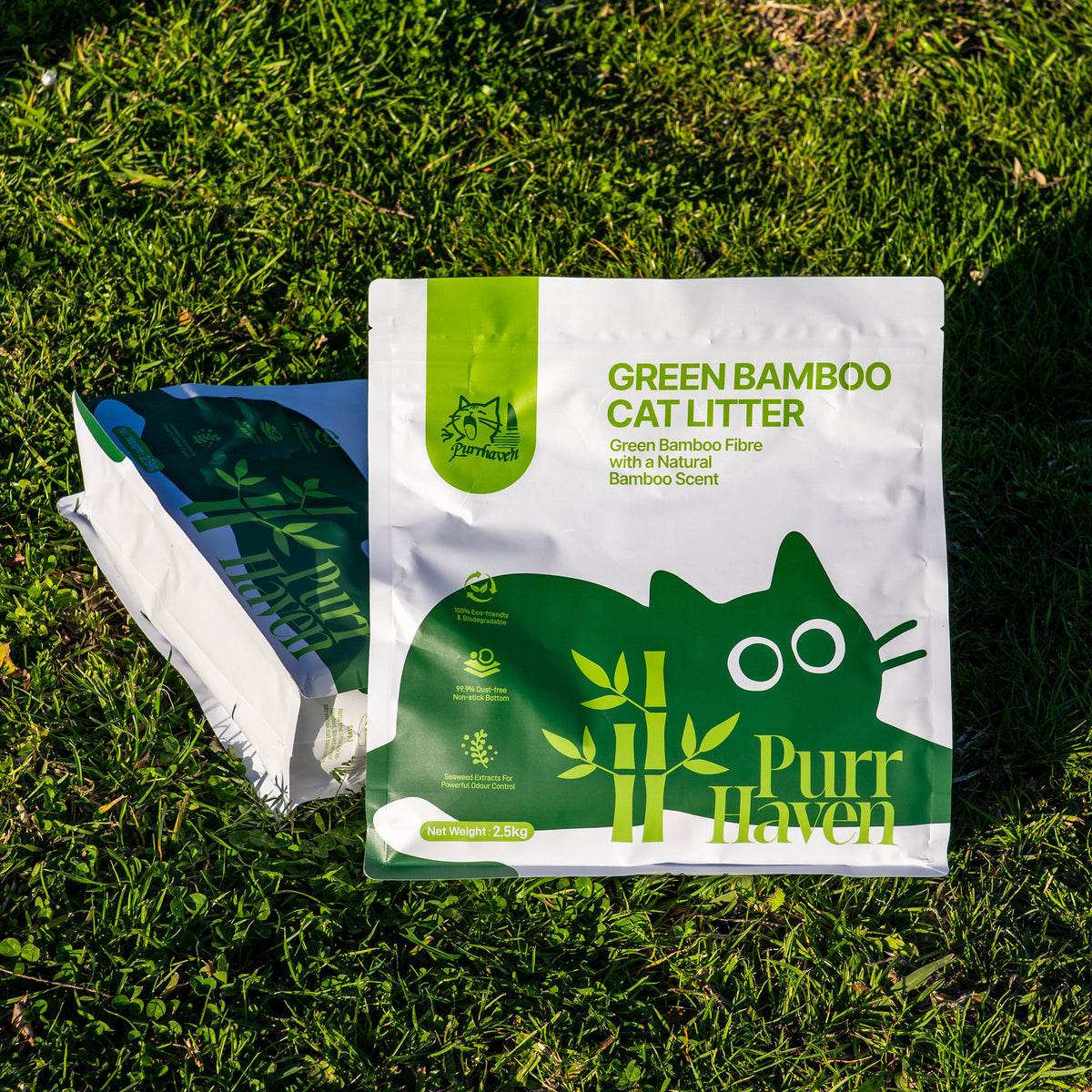 Green bamboo cat litter bag with Purr Haven branding, lying on grass.