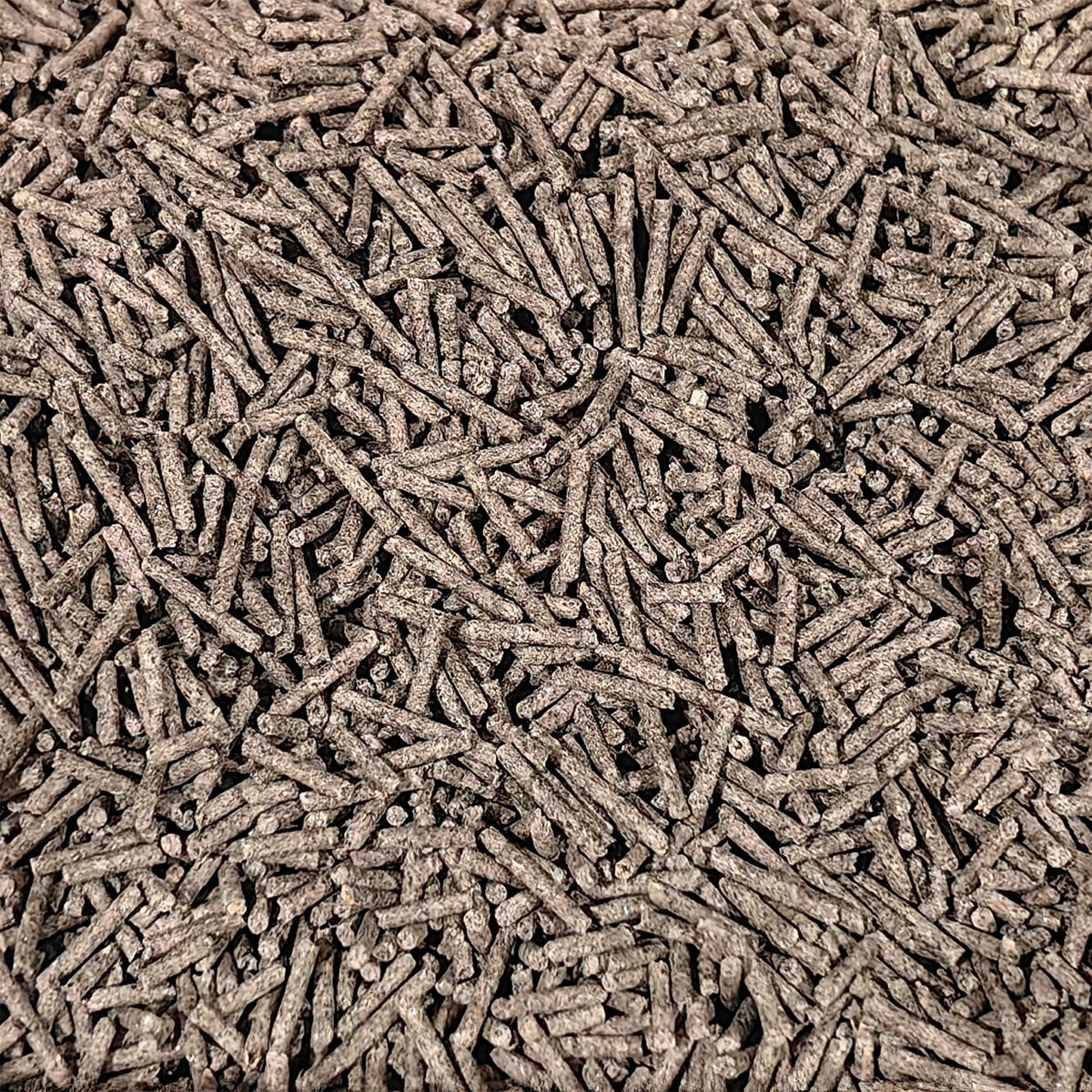 Cat litter pellets, dark gray and tan speckled