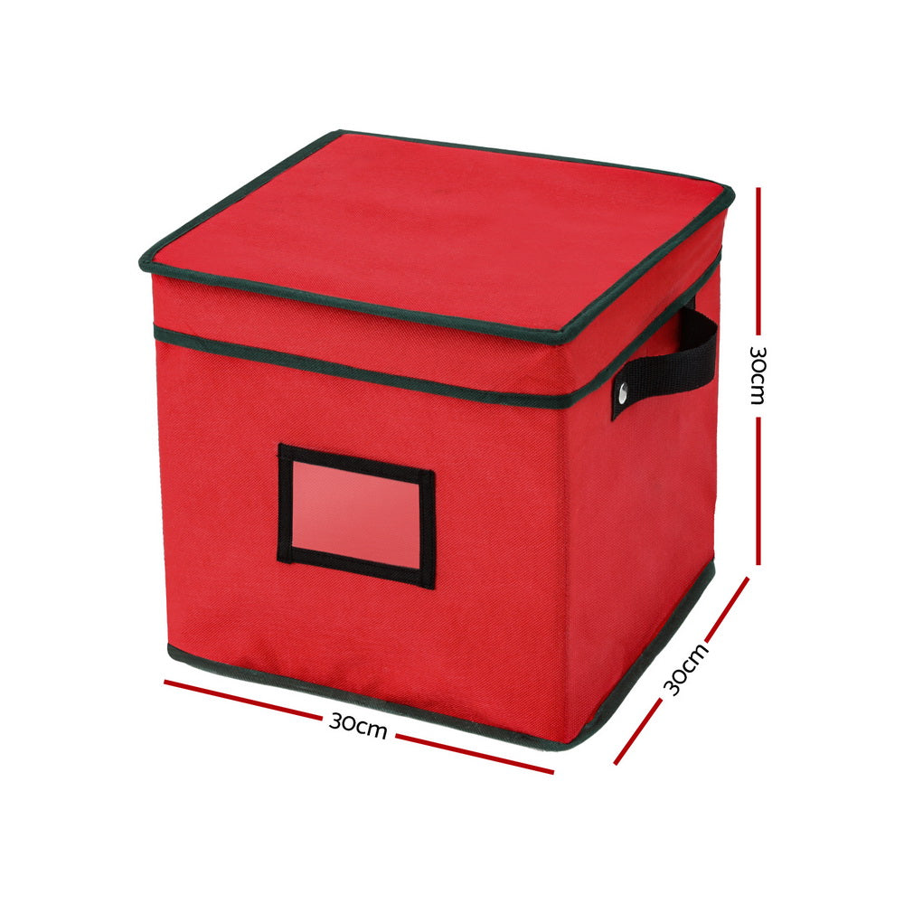 Red fabric ornament storage box with folding lid, black handle, and front window panel