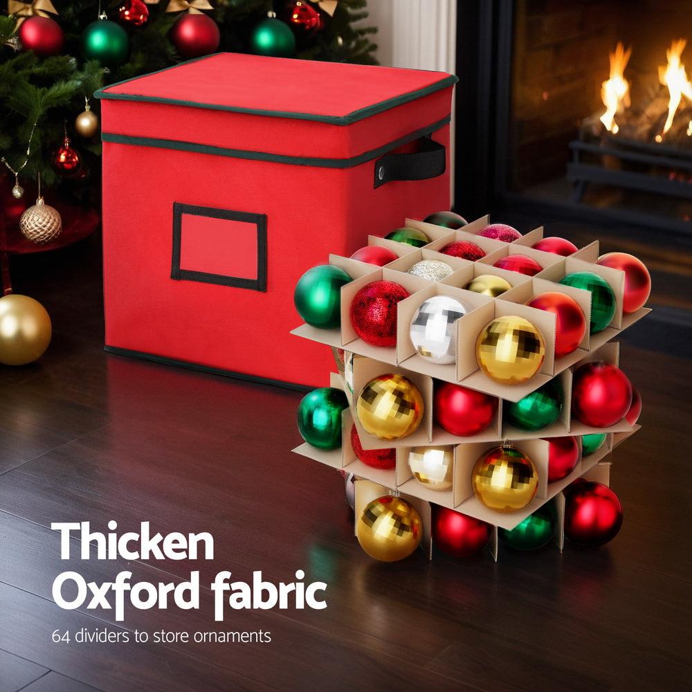 Red ornament storage box with divider grid holding assorted Christmas baubles