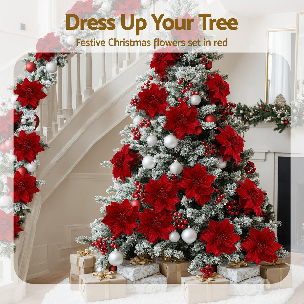 Red poinsettia flower set decorating a Christmas tree with layered blooms