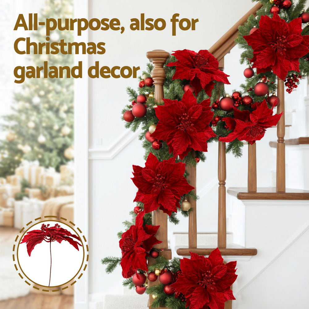 Red poinsettia flower garland with multiple blooms and shiny centers for Christmas decor