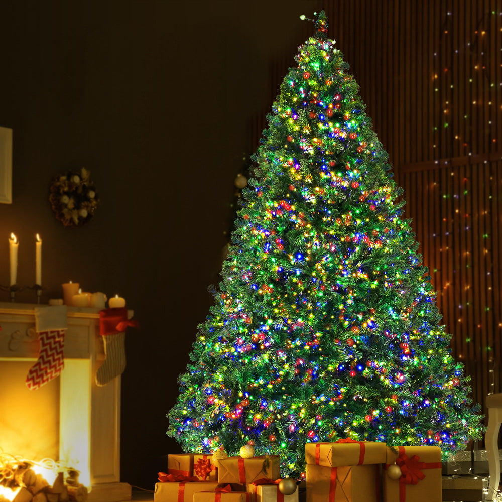 Artificial Christmas tree with multicolor LED lights, decorated topper and base