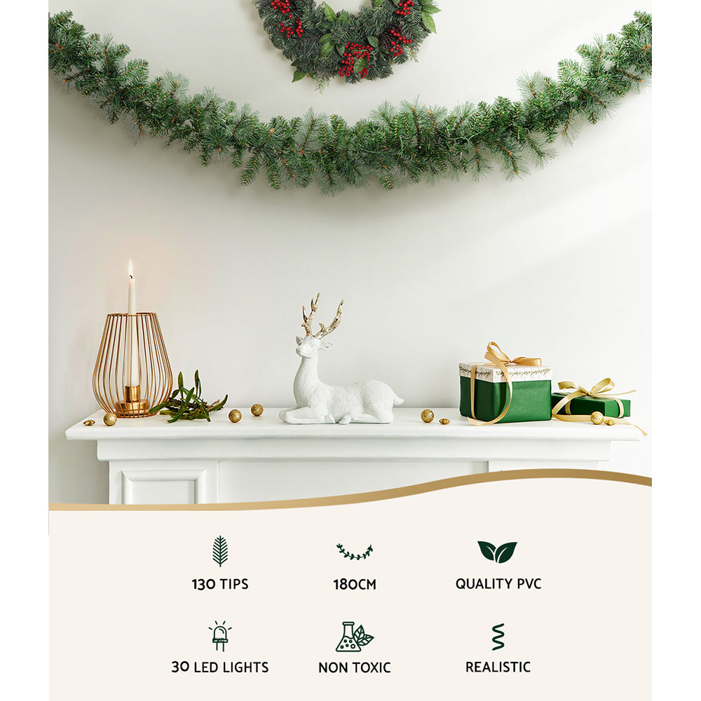 Green LED Christmas garland with warm white lights draped along mantel