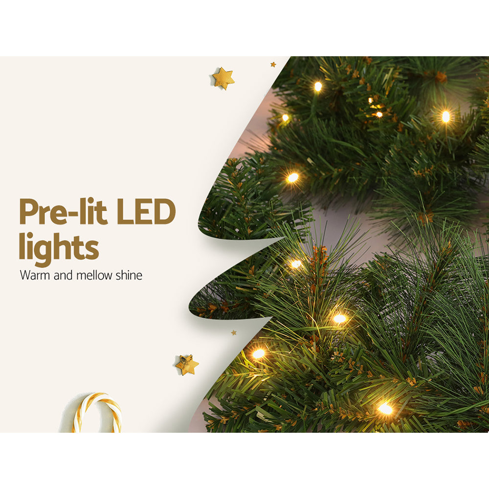 Green Christmas garland branch with warm white LED lights