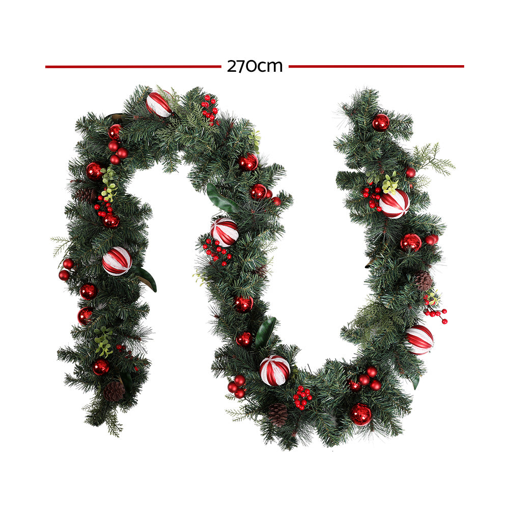 Artificial Christmas garland, dark green with red ornaments and striped ribbon baubles