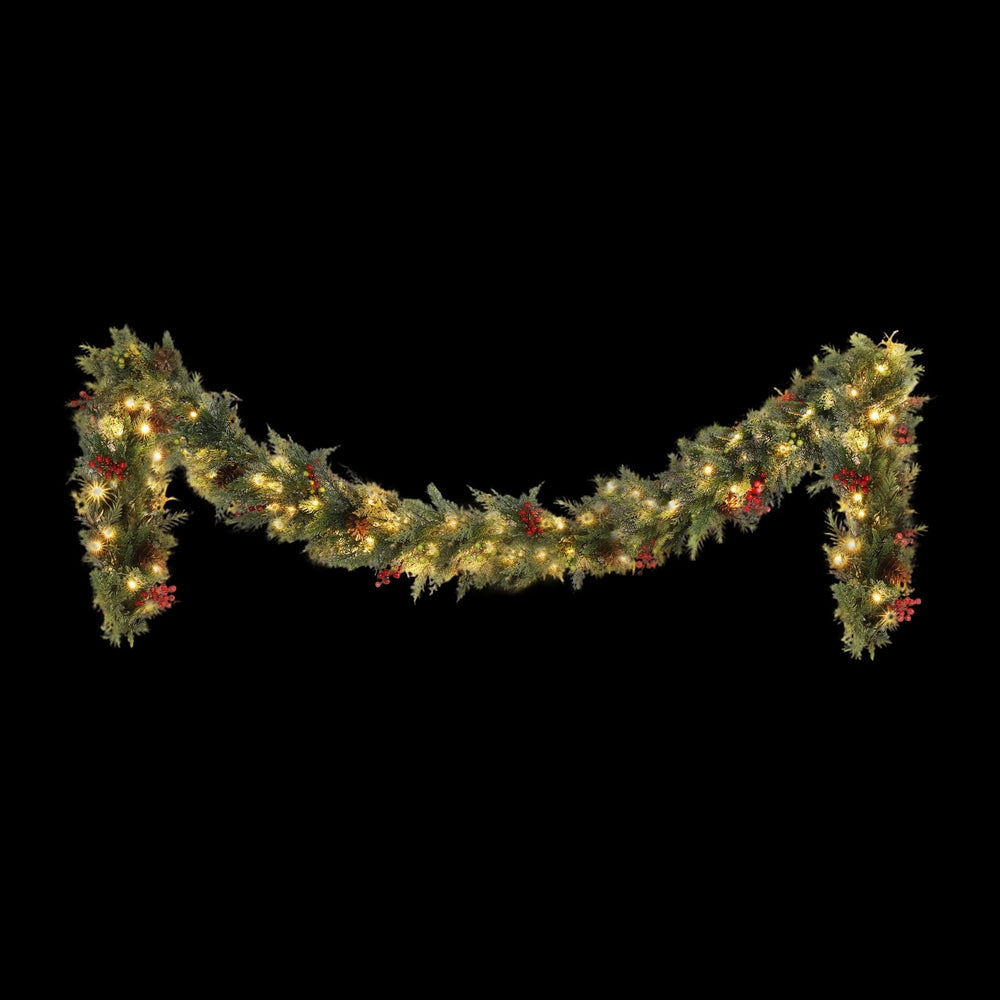 Warm white LED Christmas garland with pine cones, red berries, and green foliage