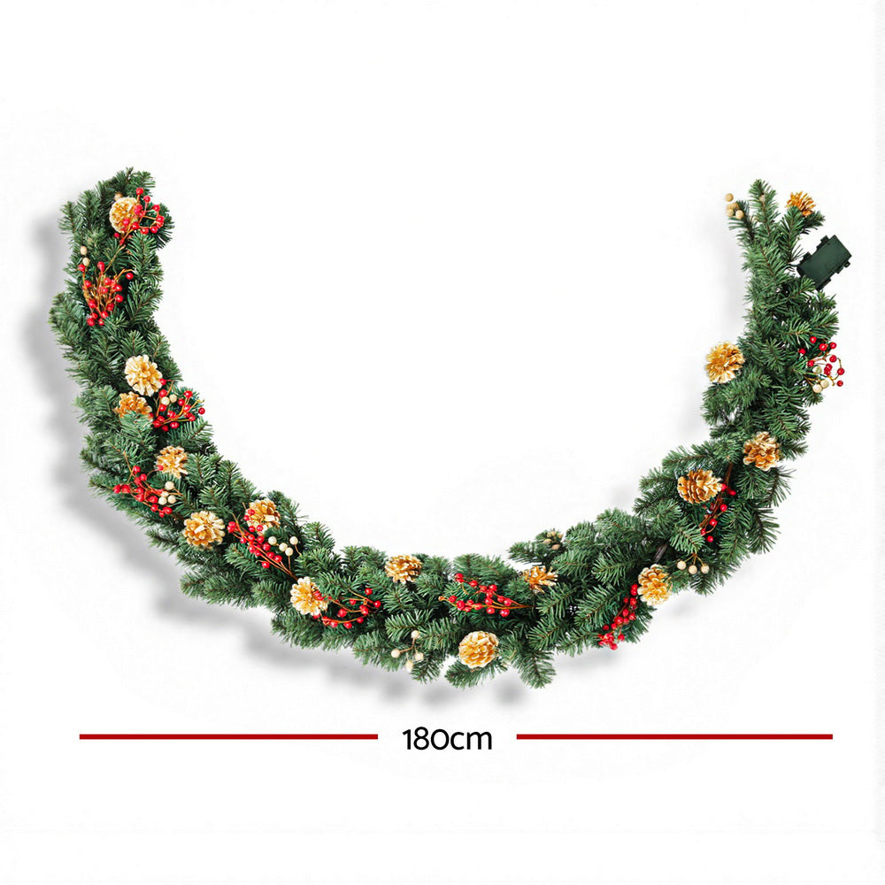 Arched Christmas garland with pine greenery, gold pine cones, and red berry clusters