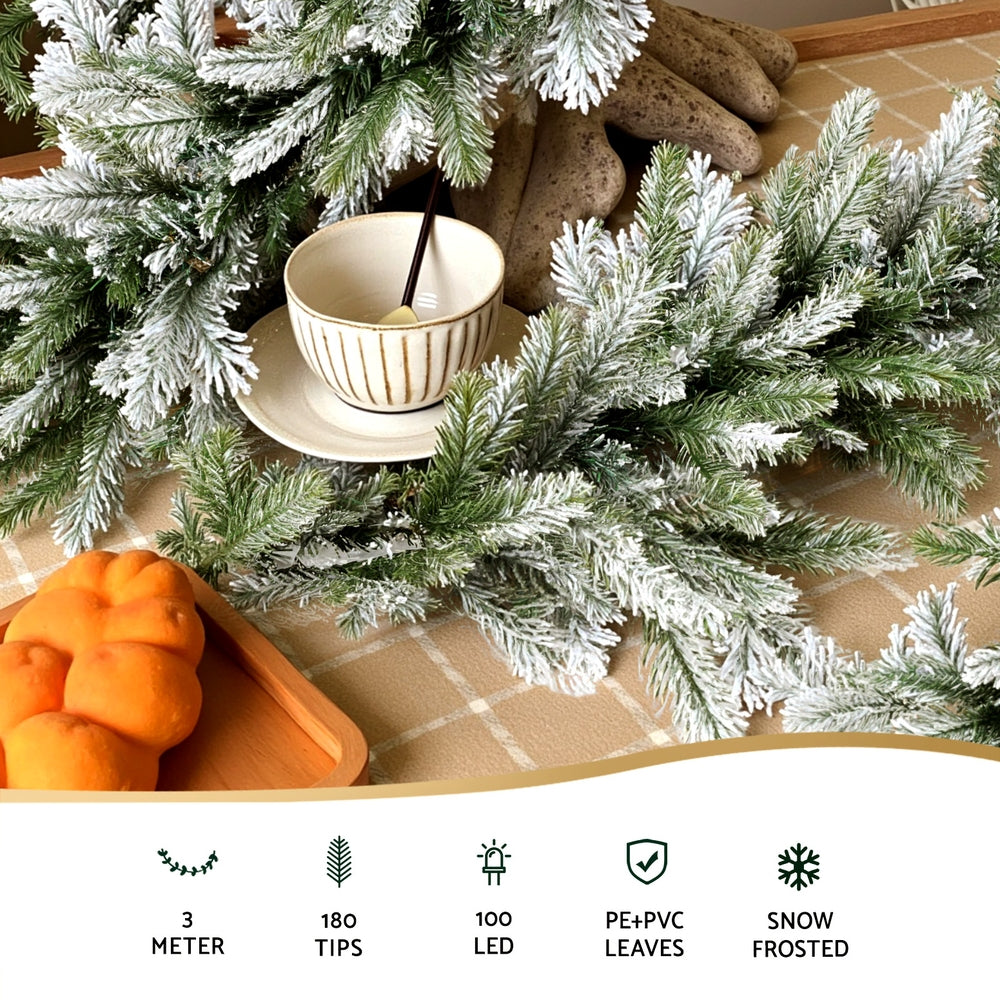 Frosted green pine garland with warm white LEDs draped along stair railing