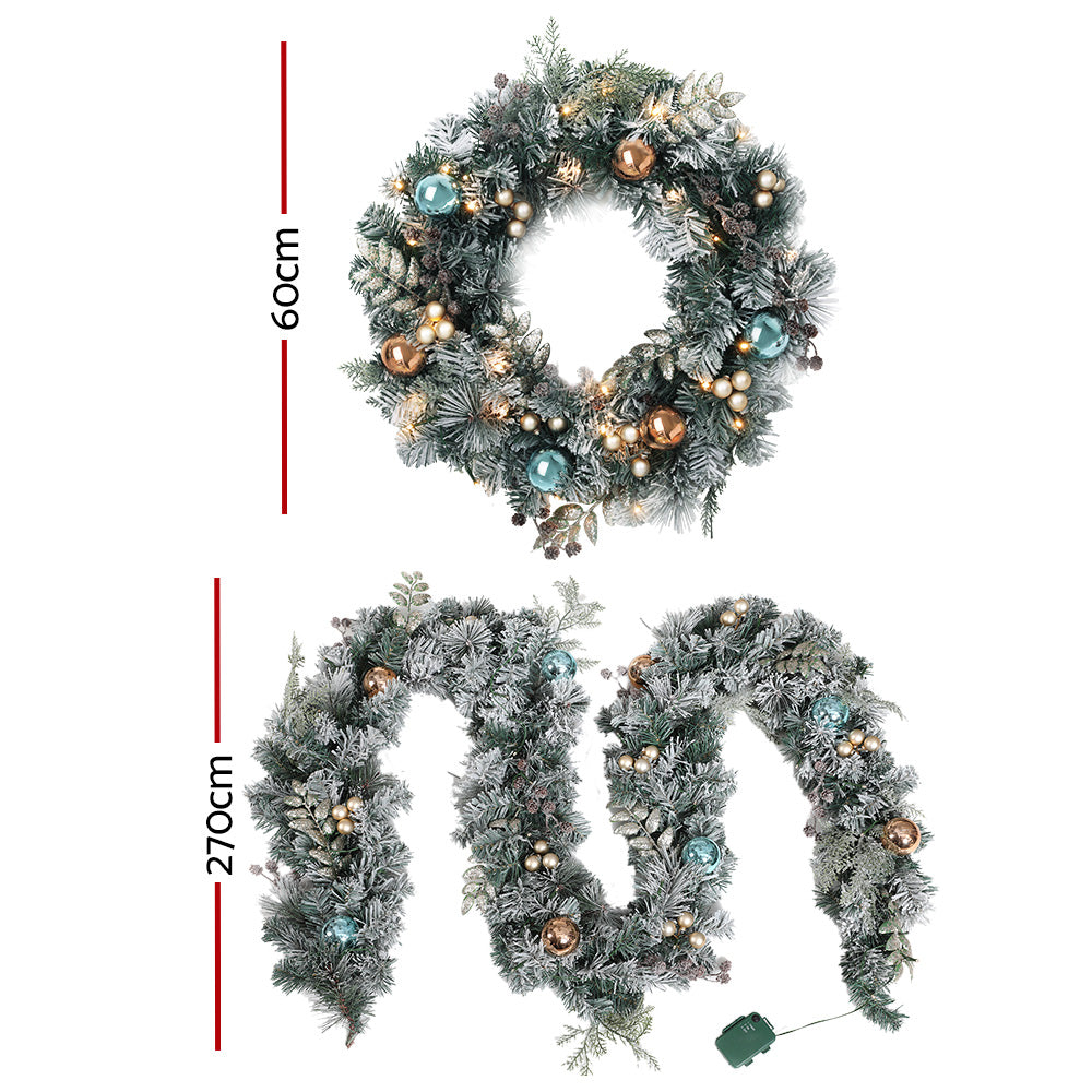 Frosted garland and wreath set with LED lights, teal and gold baubles, and pine accents
