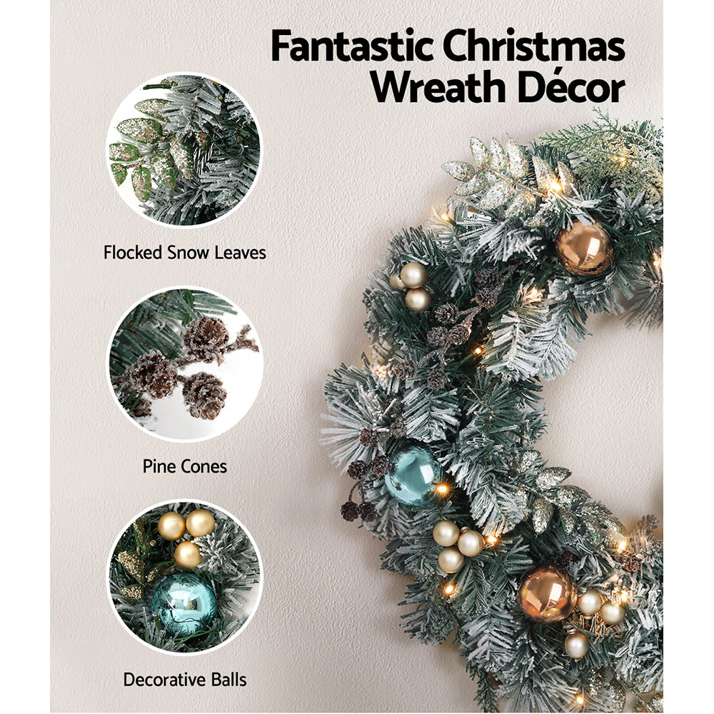 Flocked Christmas wreath decor with LED lights and mixed teal, gold, and bronze baubles