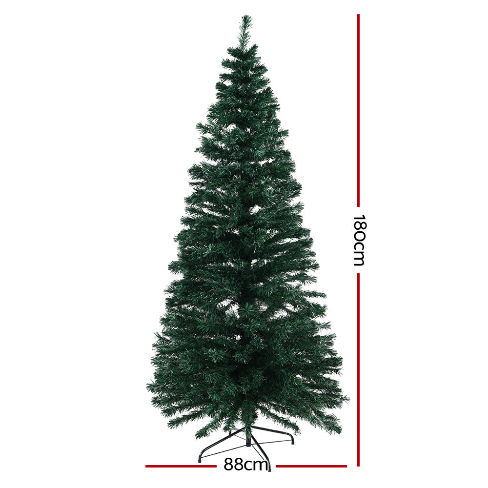 Warm white lit artificial Christmas tree, 180cm tall and 88cm wide base.