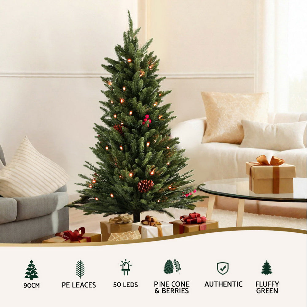 Mini artificial Christmas tree with warm white LED lights, pine cones, and red berry details