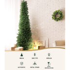 Pre-lit artificial Christmas tree with warm LED lights and metal stand