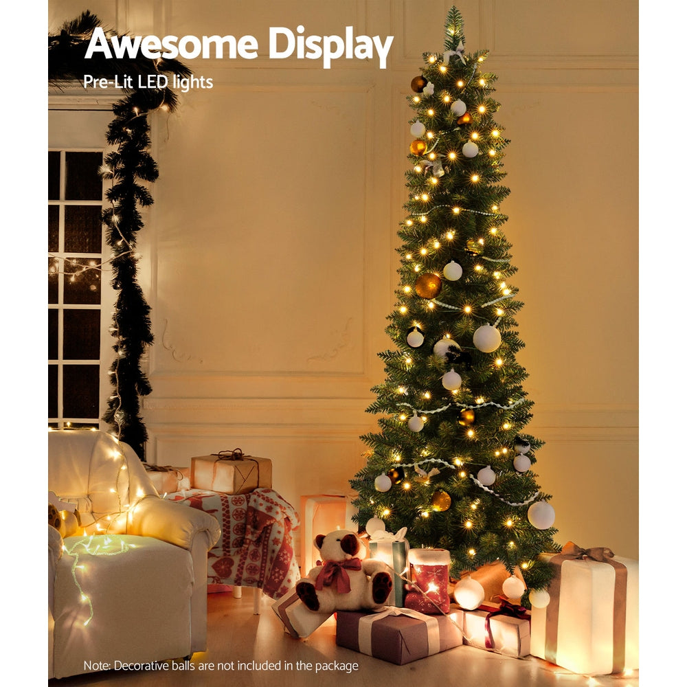 Pre-lit artificial Christmas tree with warm LED lights and hanging baubles