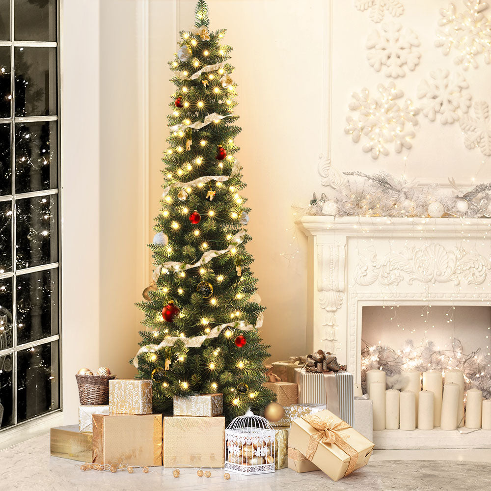 Artificial Christmas tree with warm LED lights and colorful hanging baubles