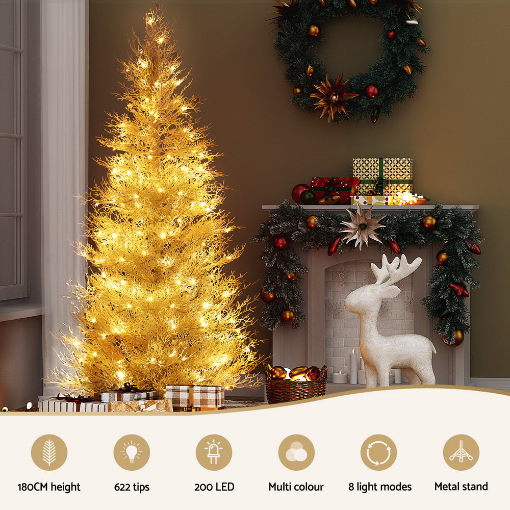 Frosted Christmas tree with warm yellow LED lights on metal stand