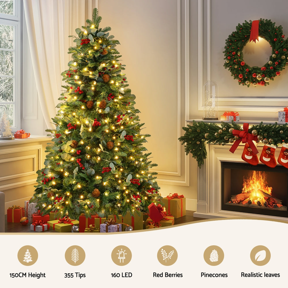 Pre-lit Christmas tree with warm yellow lights, red berries, pinecones, and full foliage