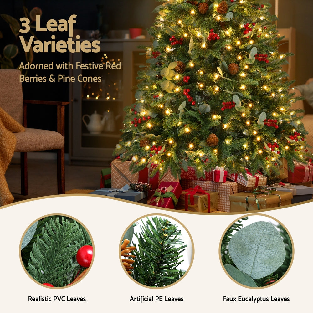Pre-lit Christmas tree with warm yellow lights, red berries, pinecones, and decorative leaves