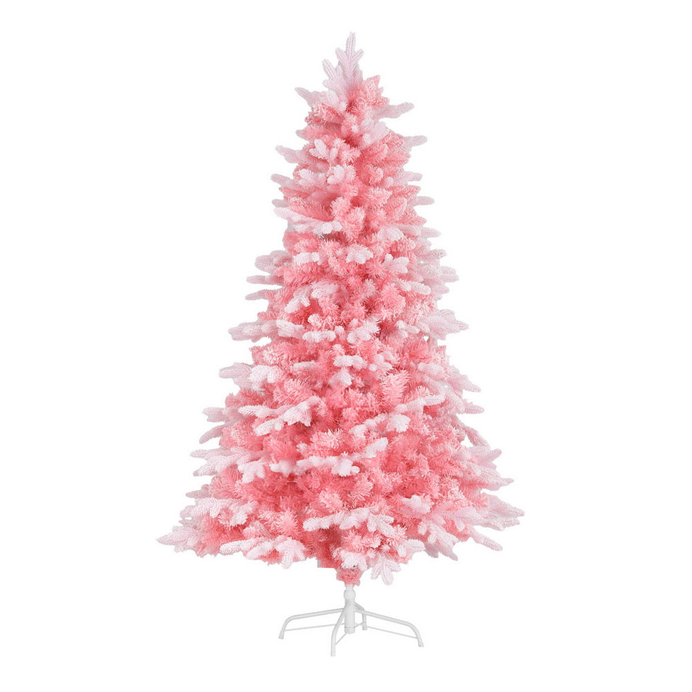 Pink snowy artificial Christmas tree with dense, snowy white-tipped foliage