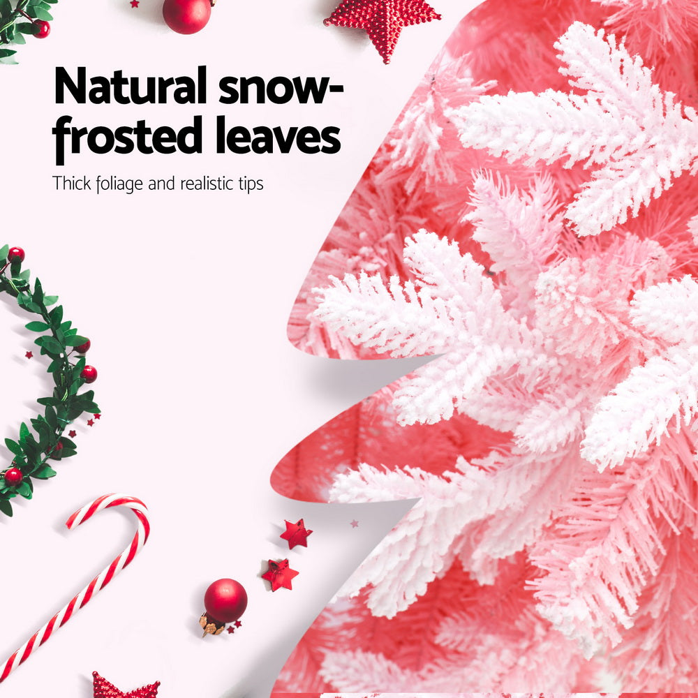 Snow-frosted pink artificial Christmas tree tips with thick, fluffy texture