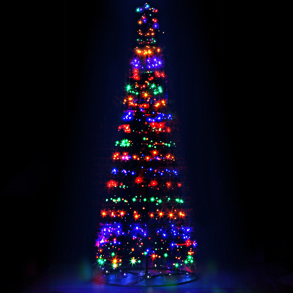 LED Christmas jingle tree with multicolor lights and star topper on a round metal base