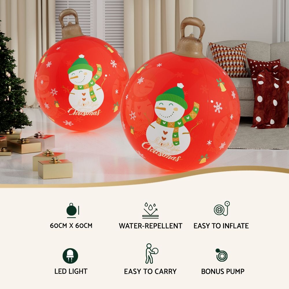 Two red illuminated inflatable Christmas balls with snowman graphics and carry handles