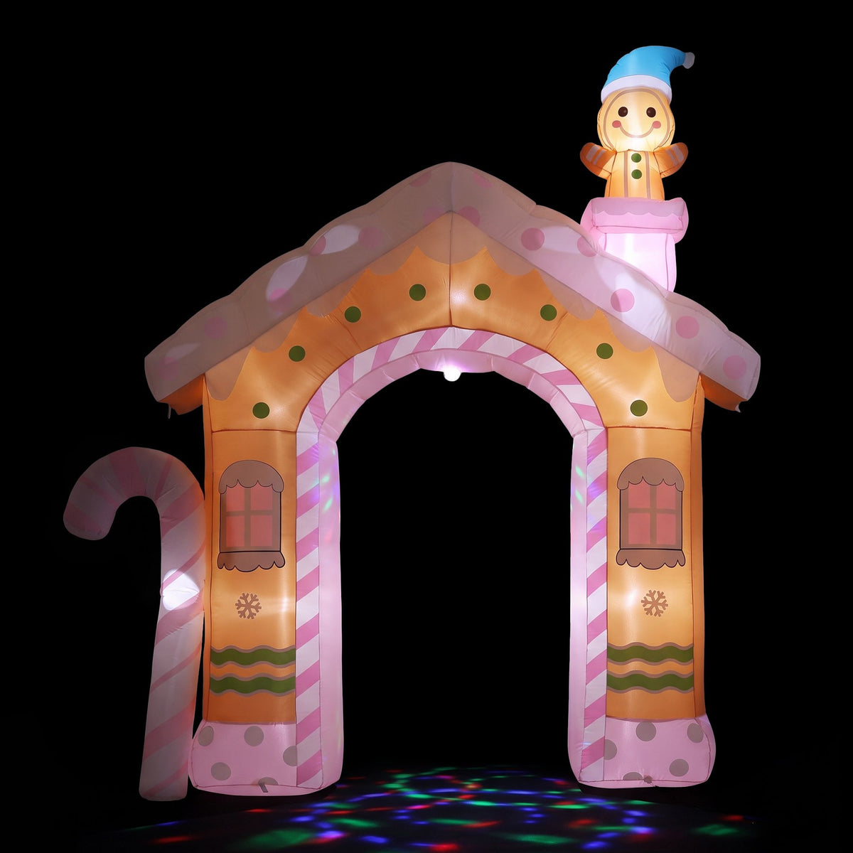 Inflatable gingerbread house with glowing pink light arch and nutcracker topper figure