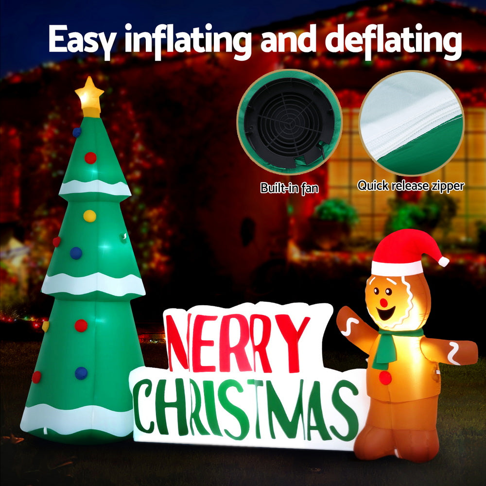 Inflatable Christmas tree with Merry Christmas sign and glowing gingerbread character
