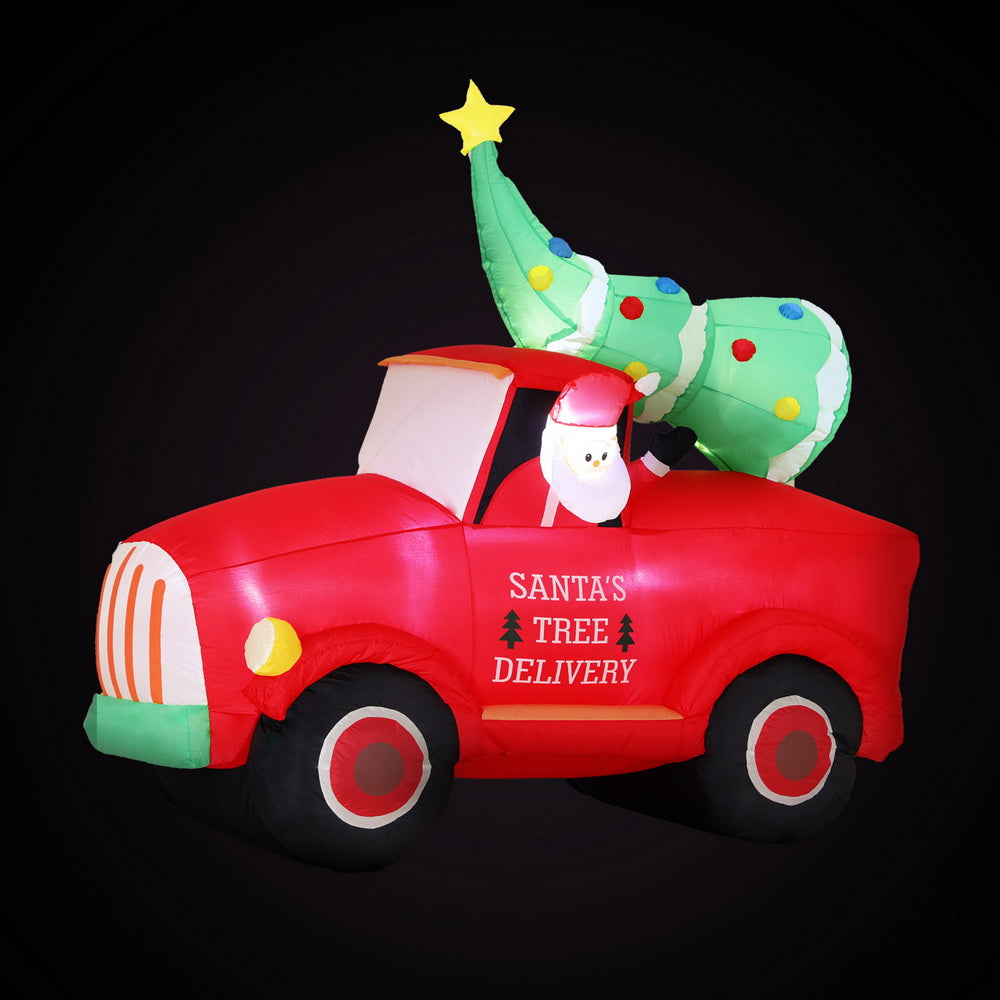 Inflatable red Santa tree delivery truck with green topper and LED lights