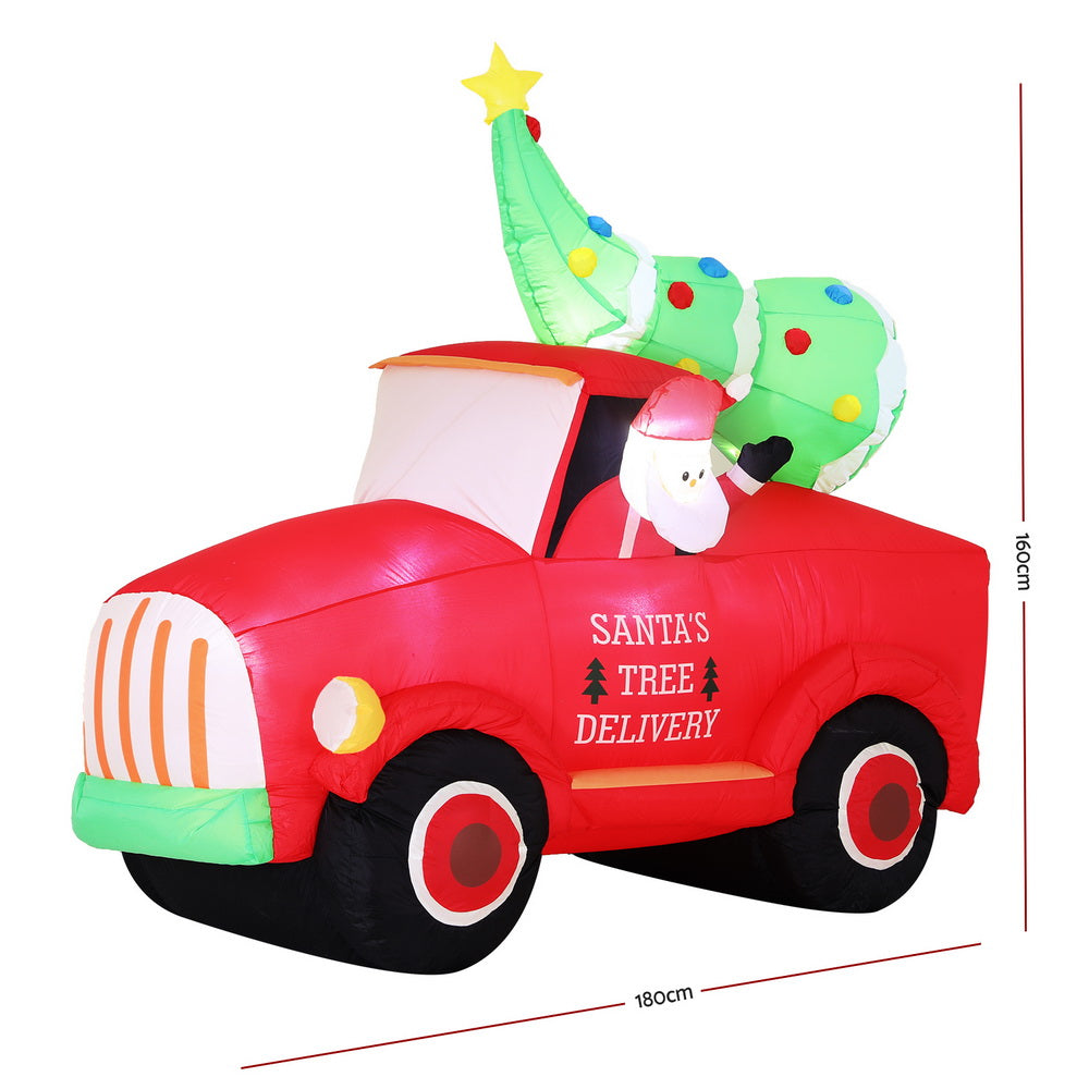 Inflatable Santa tree delivery truck with green tree topper and measurement view
