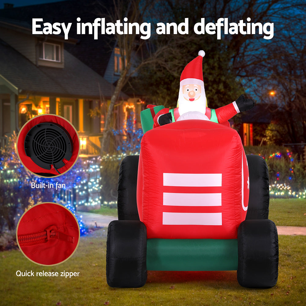 Inflatable Santa truck with red cab, green boots, black tires; fan and zipper access shown