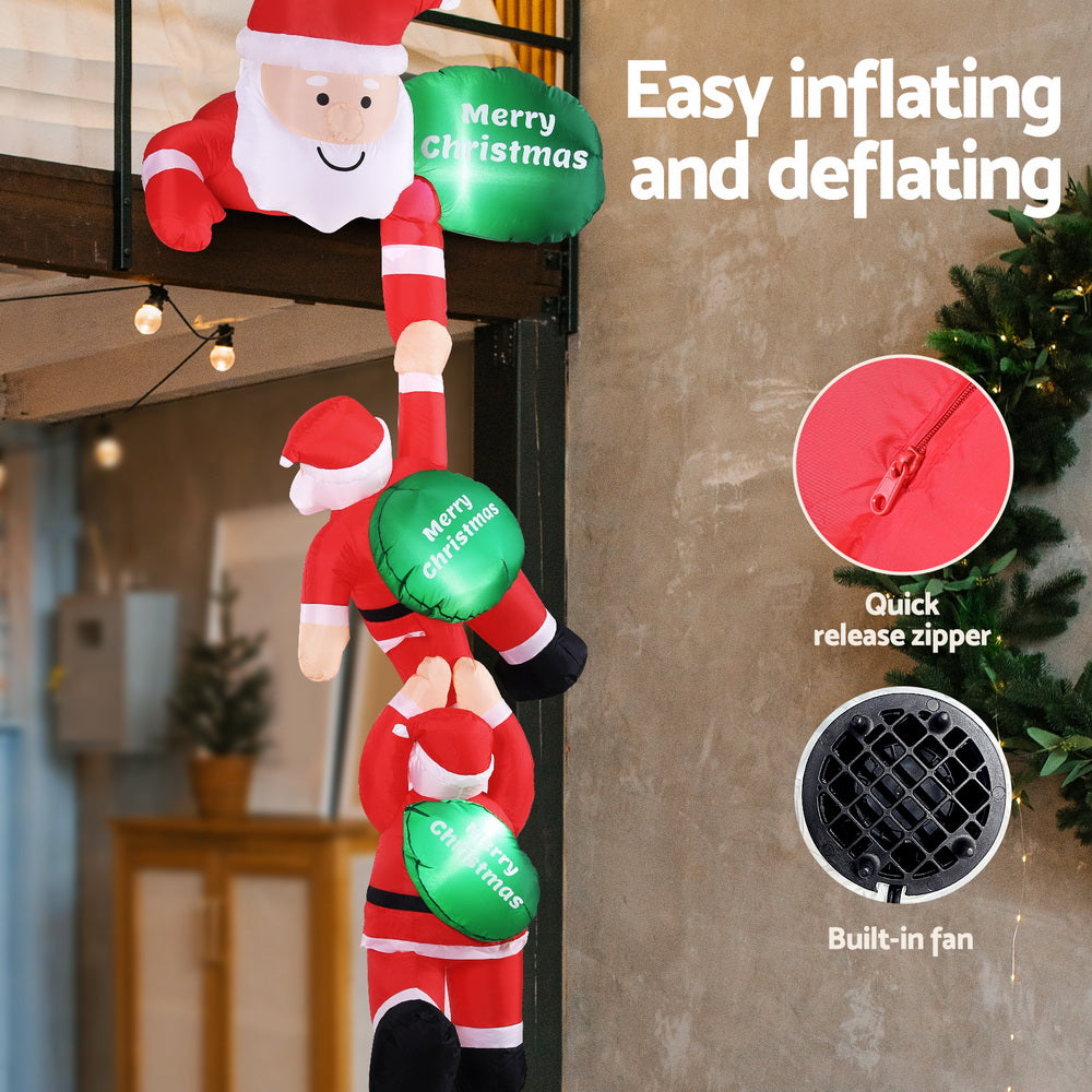 Inflatable climbing Santa with green glowing “Merry Christmas” balloons and built-in fan