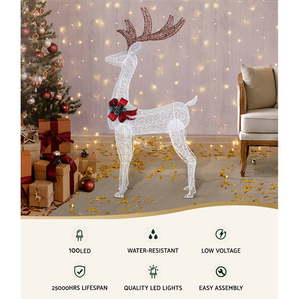 Lighted white reindeer decoration with red bow and glittering LEDs, full-body standing